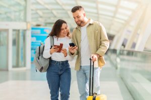 A couple being happy about their travel loyalty benefits.