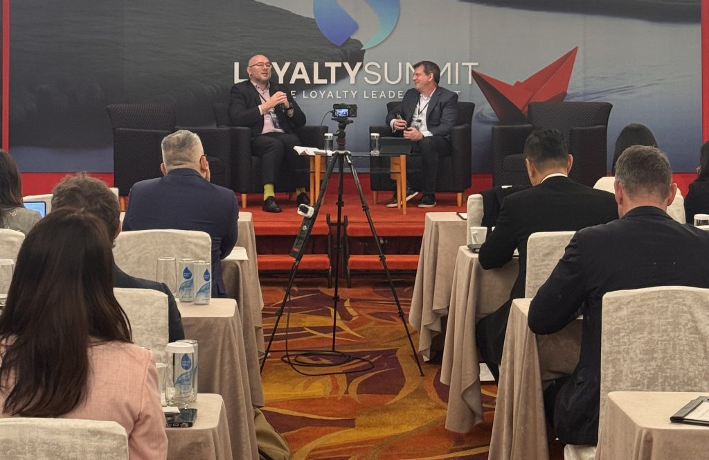 Loyalty experts listening to a Panel Discussion about Loyalty Trends 2025