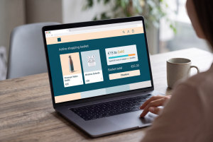 Person shopping online on a laptop with a real-time loyalty status update