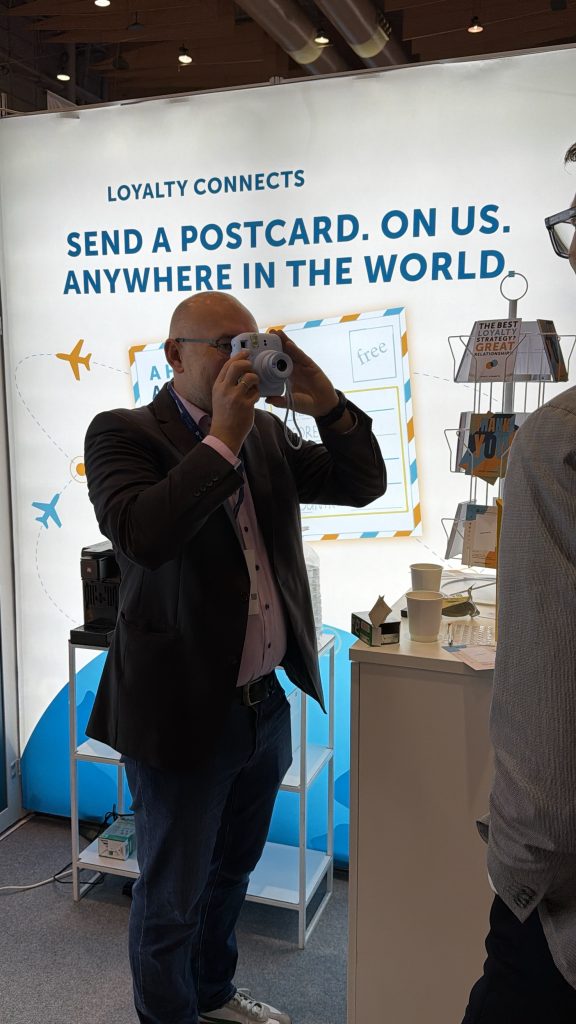 Attendee tries LPS’s postcard experience at WAF 2026.